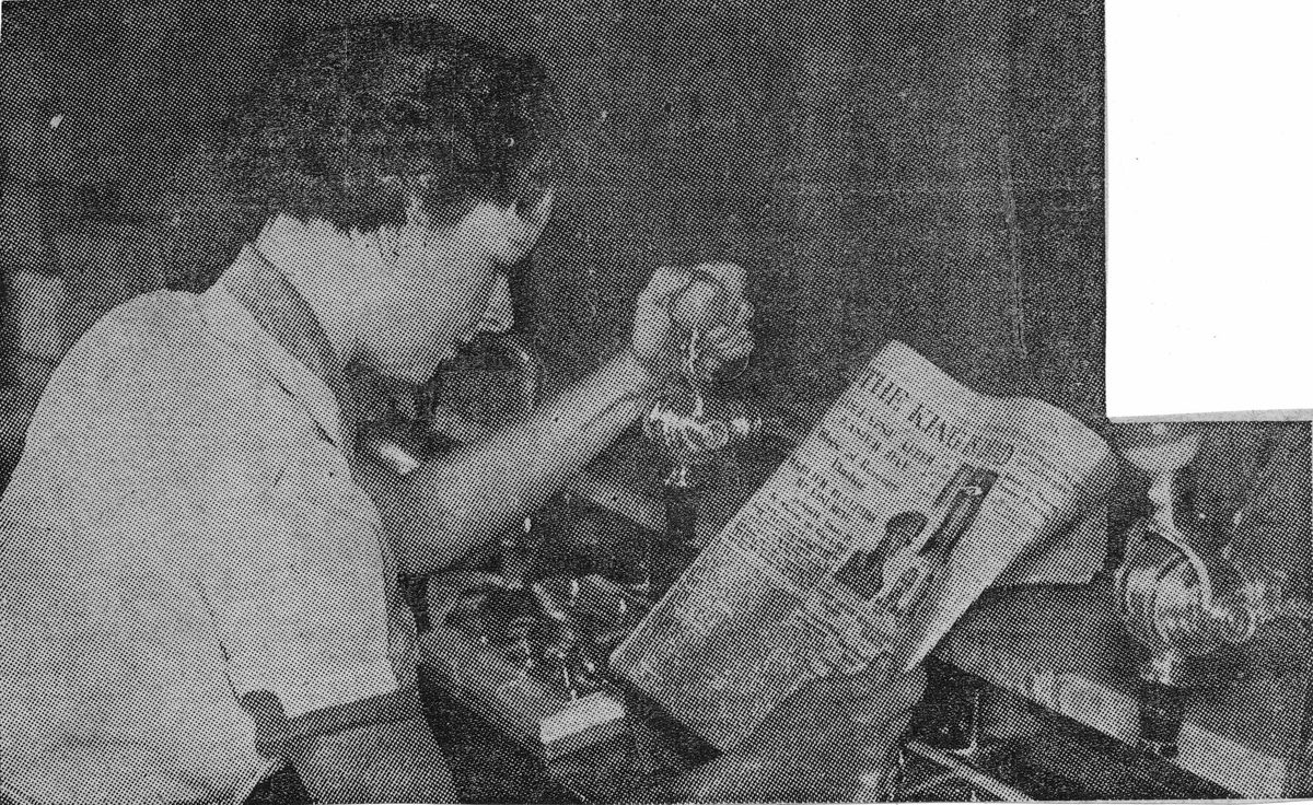 Woman reading a newspaper announcing the death of King George V, Brisbane, 1936