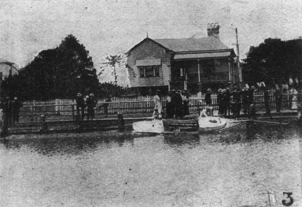 People gathered on the shore inspecting an upturned boat, Wynnum, 1906