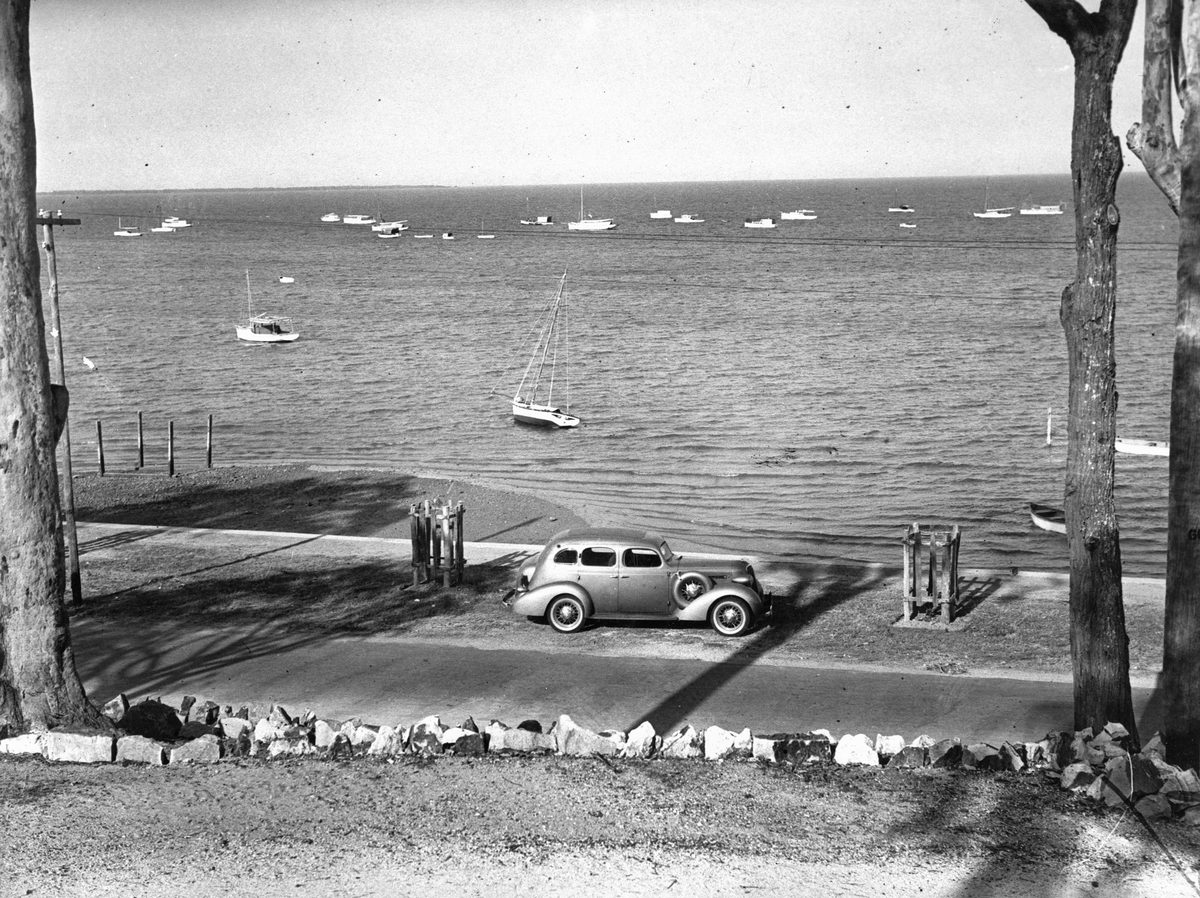 Looking over the Esplanade at Wynnum to the moored craft in the bay, 1936