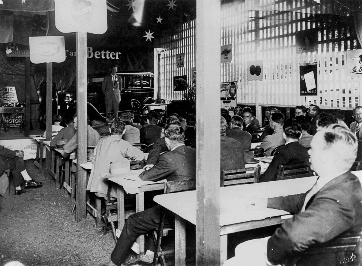 Delegates at the 1928 Dealers Convention looking at a new Oldsmobile