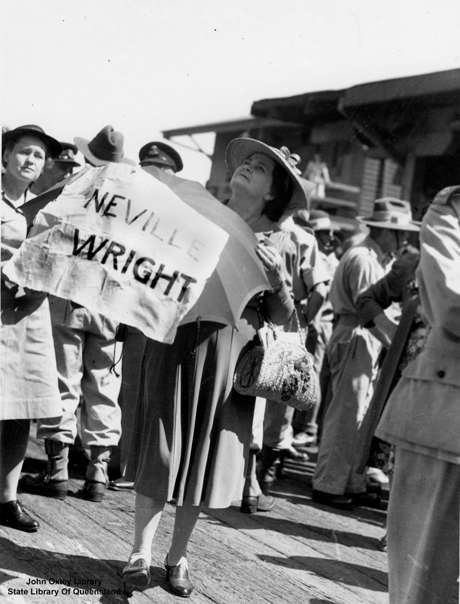 Woman waiting on a Brisbane wharf for her son, a returning prisoner of war
