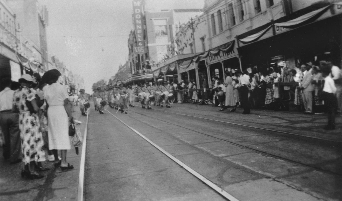 Military band marches down George Street as part of the procession for Queen Elizabeth II, Brisbane, 1954