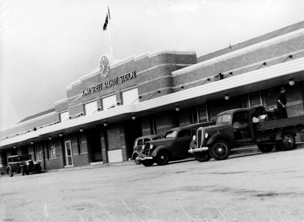Motor vehicles parked in front of the Roma Street Railway Station, Brisbane, 1940