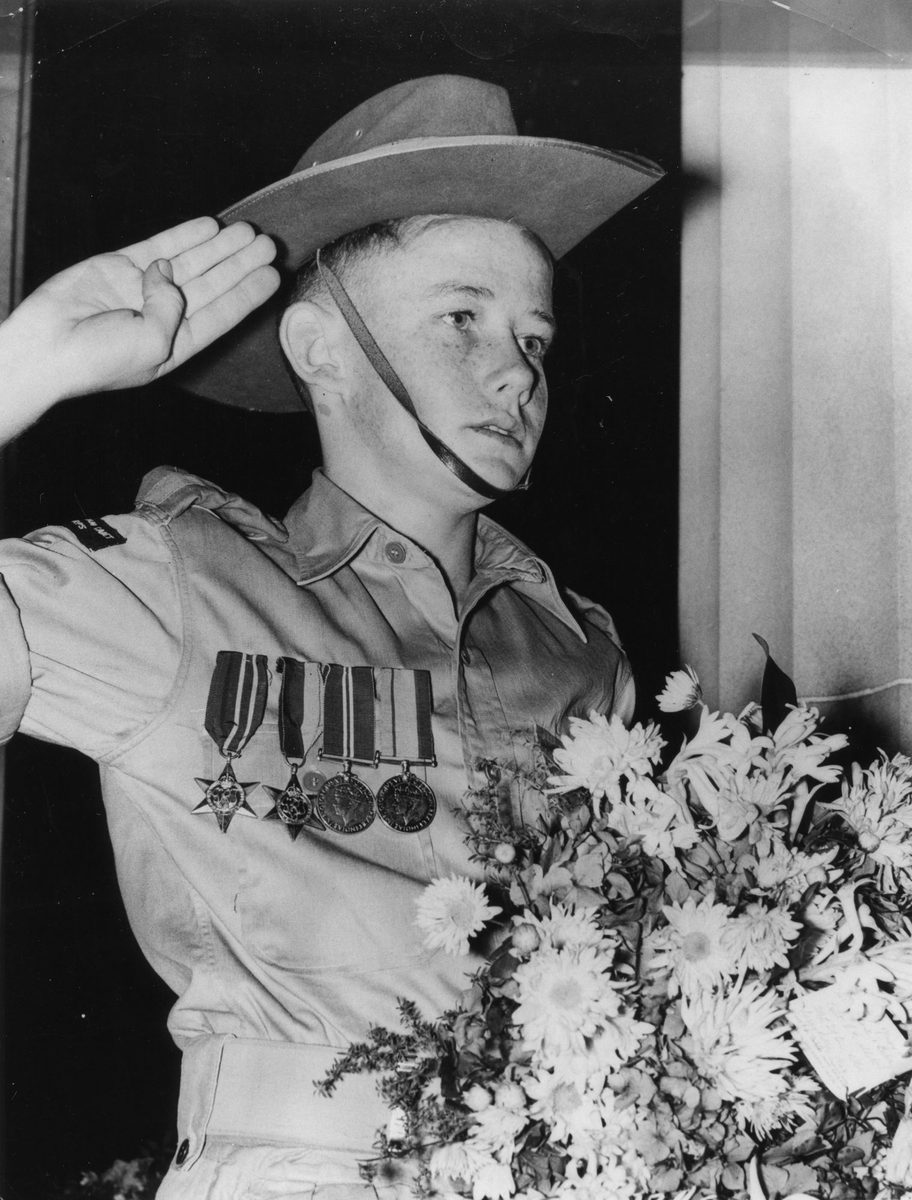 Soldier's son wearing his father's medals on Anzac Day, Brisbane, 1954