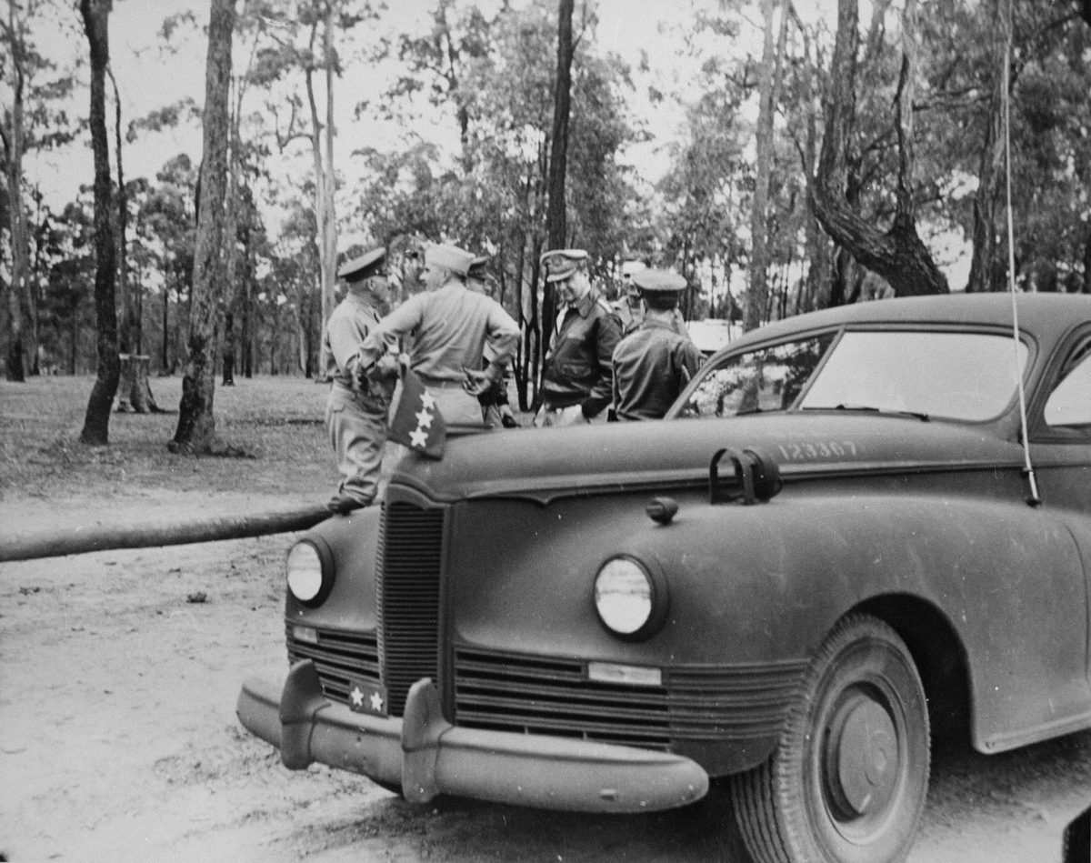 General Douglas MacArthur standing with five other soldiers at Camp Strathpine, 1944