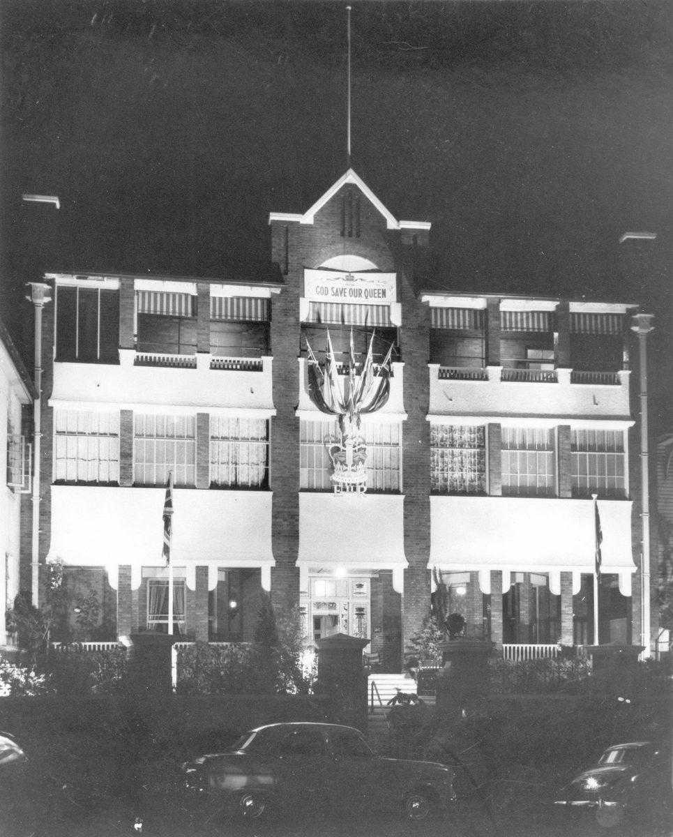 External view of the United Service Club premises on Wickham Terrace decorated for the royal visit, Brisbane, 1954