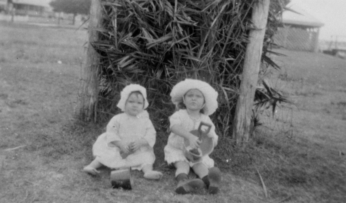 Two little children playing with their buckets and spades at Cribb Island, 1926