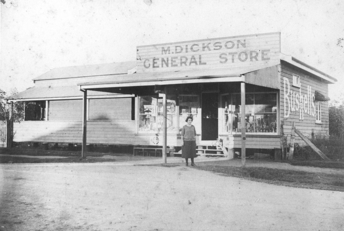 Miss Dickson standing in front of the Dickson General store