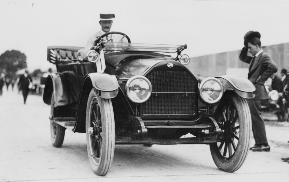 Man driving a car in the WWI peace procession, Brisbane, 1919