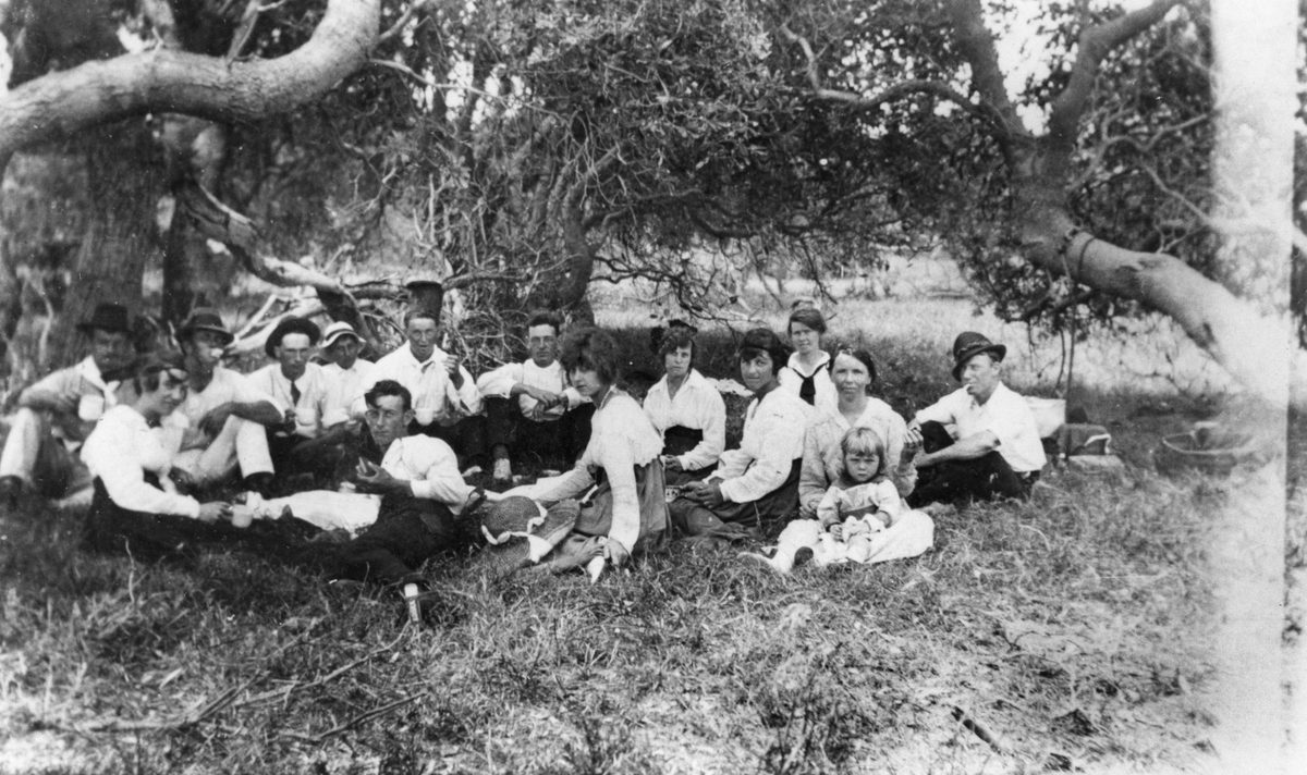 Group of people enjoying a picnic under the trees at Christmas, Moreton Island, 1919