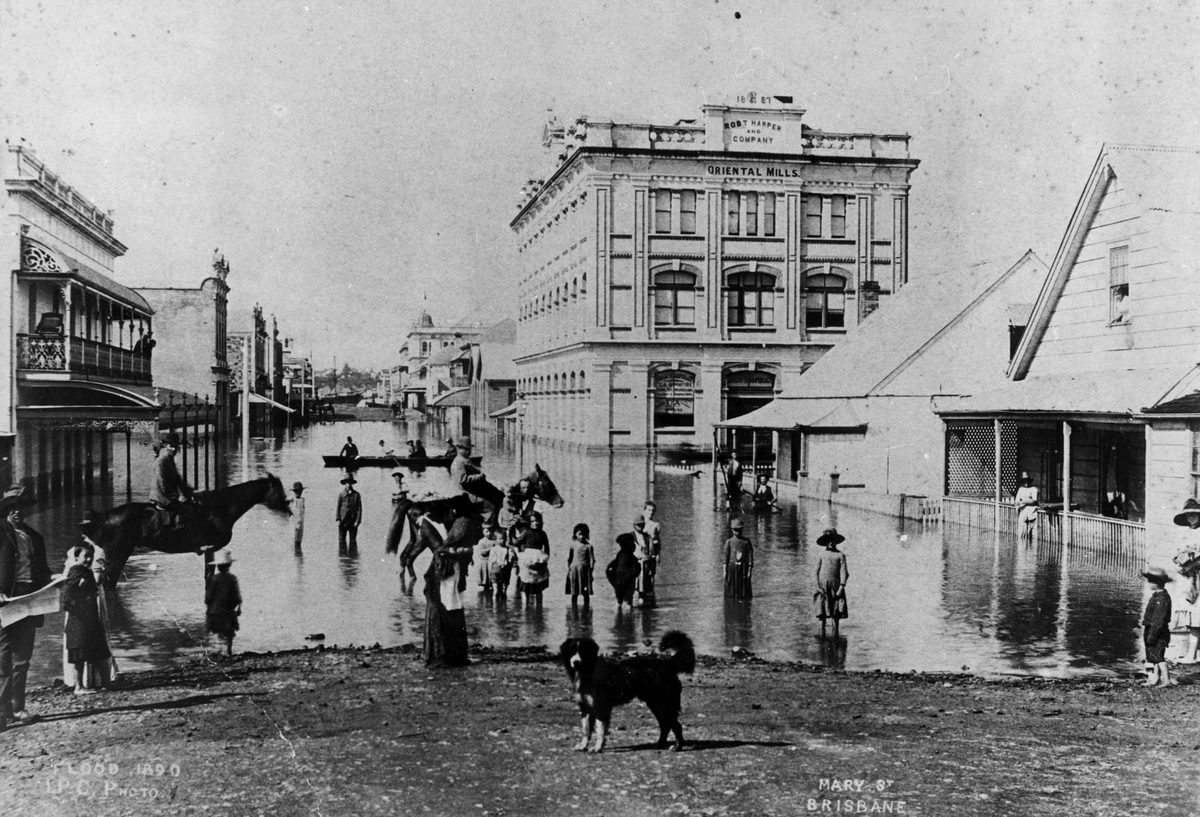 Children demonstrating the depth of flood waters in Mary Street, Brisbane, during the 1890 flood