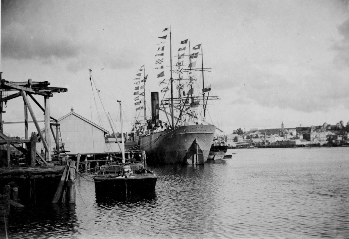 Ships docked at the wharves at South Brisbane Reach, Brisbane River, Queensland, on Mafeking Day, 1900