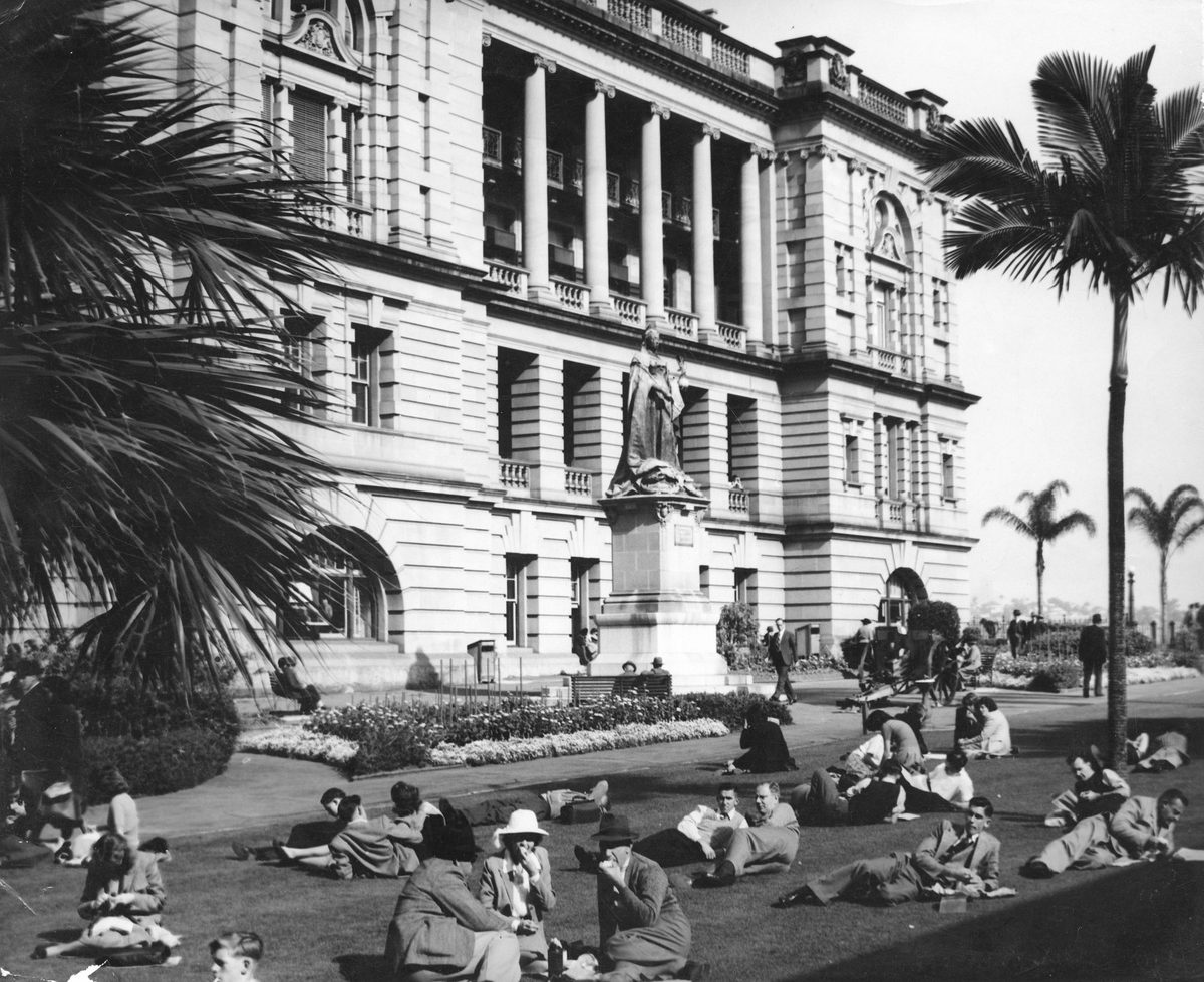 Lounging on the lawn enjoying some winter sun at Queen's Park, Brisbane, 1948