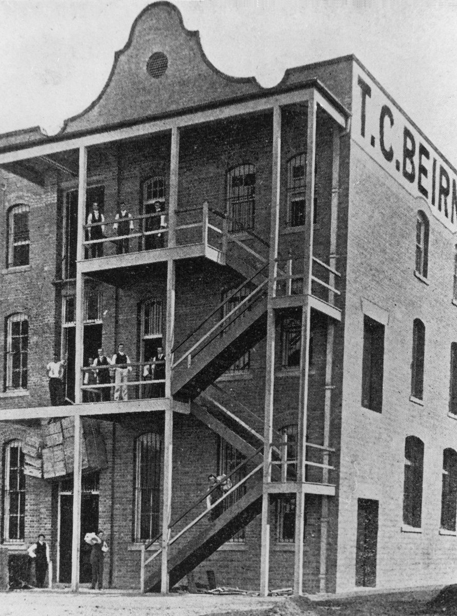 Gentlemen standing on the stairs at the rear of the T. C. Beirne building, Fortitude Valley, 1902