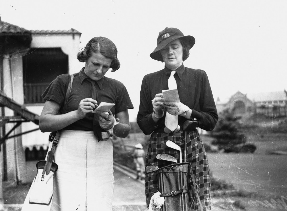 Women golfers add up their score cards, 1938