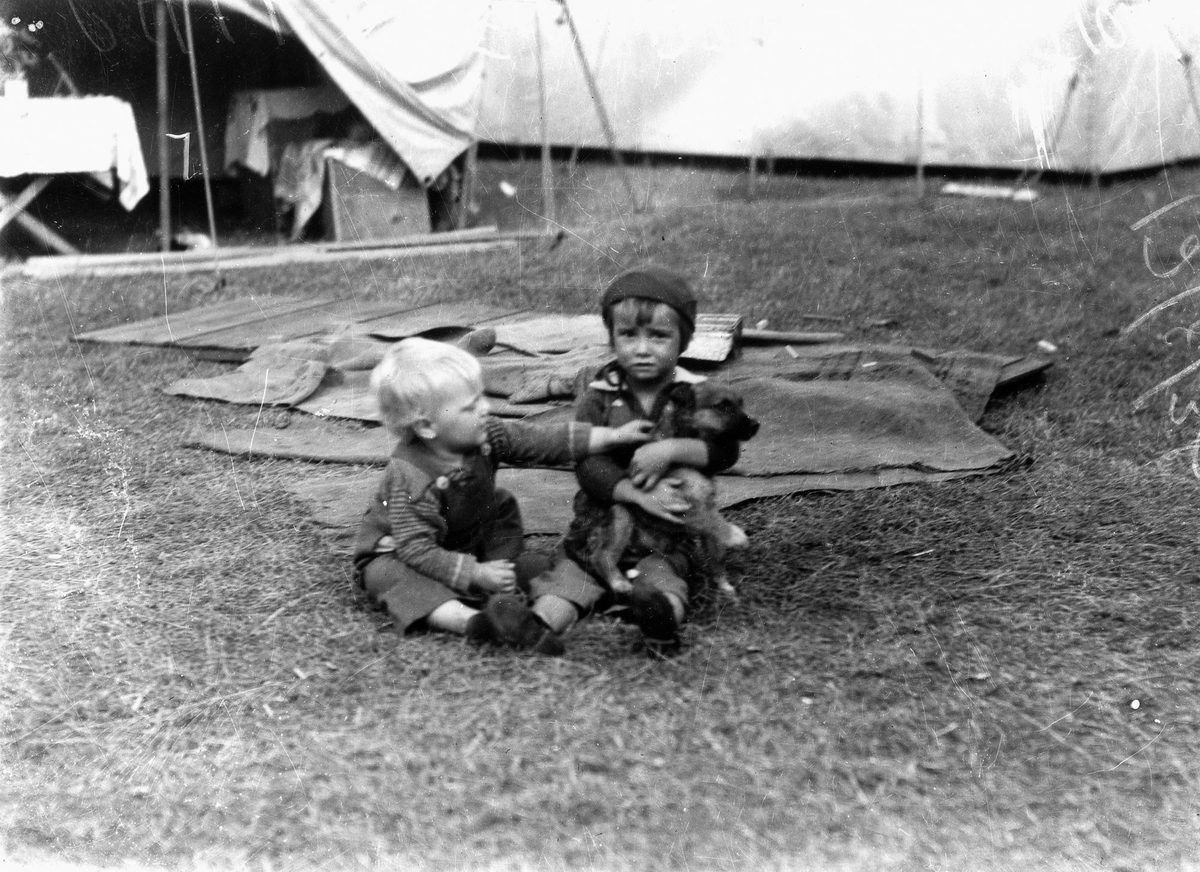 Children playing with a puppy at the Exhibition, 1938