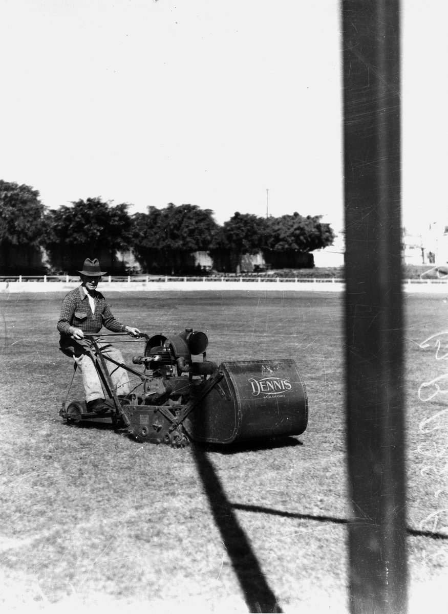 Man cutting grass at the Brisbane Exhibition, 1938