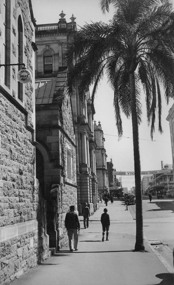 People walking along the footpath outside the police department on George Street, Brisbane, 1940