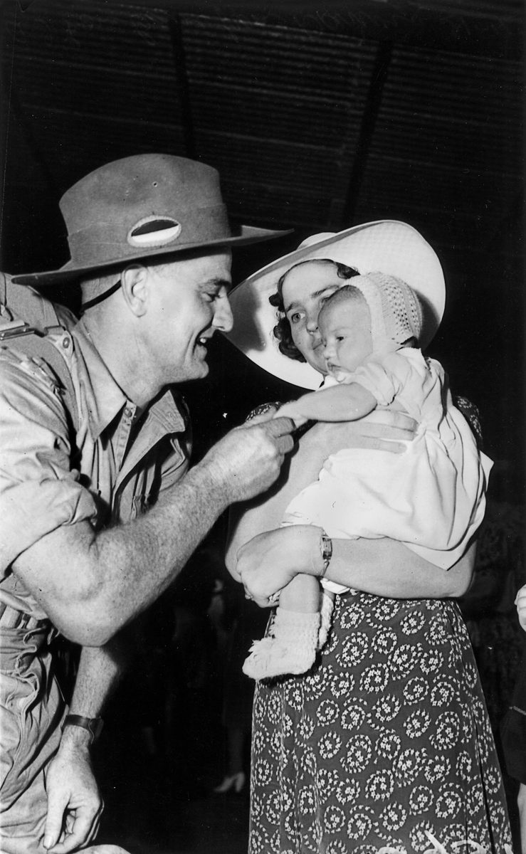 Soldier dad greeting his wife and baby on arrival home on leave from Darwin, Brisbane, November 1941