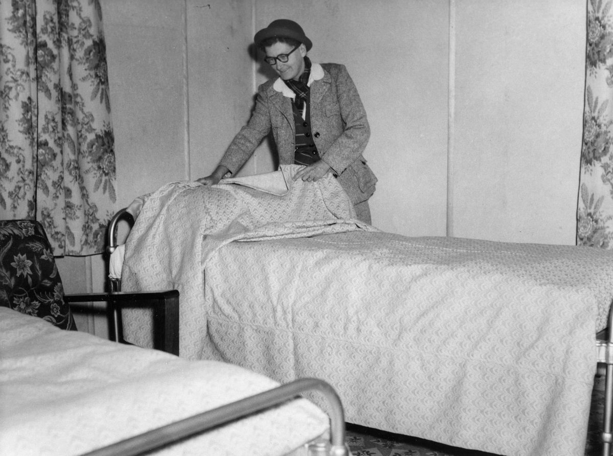 Making a bed at the Methodist Home for Discharged Women Prisoners, Geebung, 1953