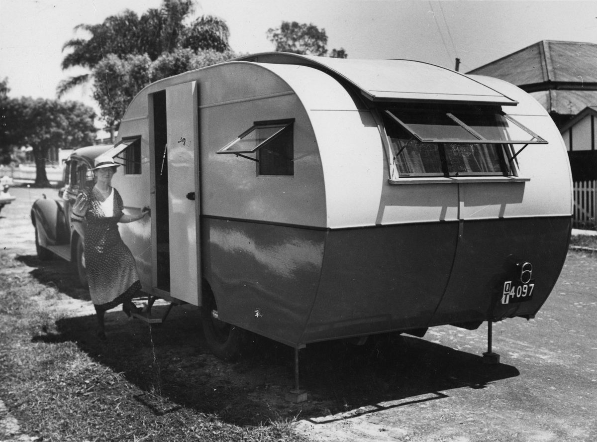 Woman stepping up into a caravan, Brisbane, 1940