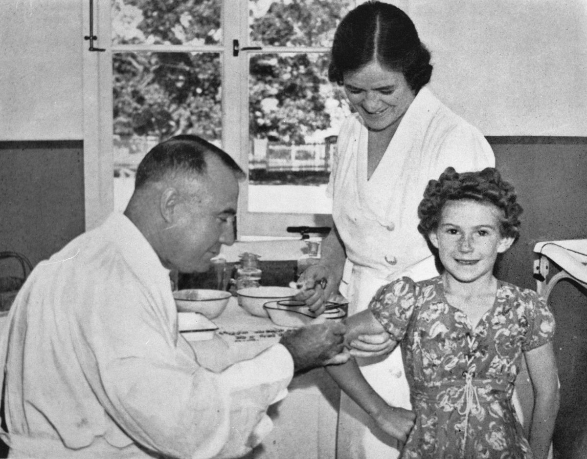 Young girl being vaccinated at Brisbane, 1940